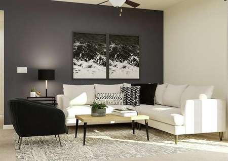 Rendering of the living room showcasing a
  large white sectional couch, black accent chair, light wood coffee table with
  black legs and a side table. An accent dark gray wall has artwork on it.