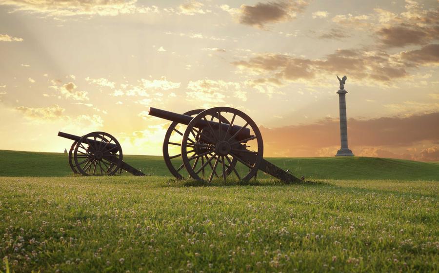 Sharpsburg, Maryland Antietam National Battlefield showing two cannons on grassy field with monument in the background