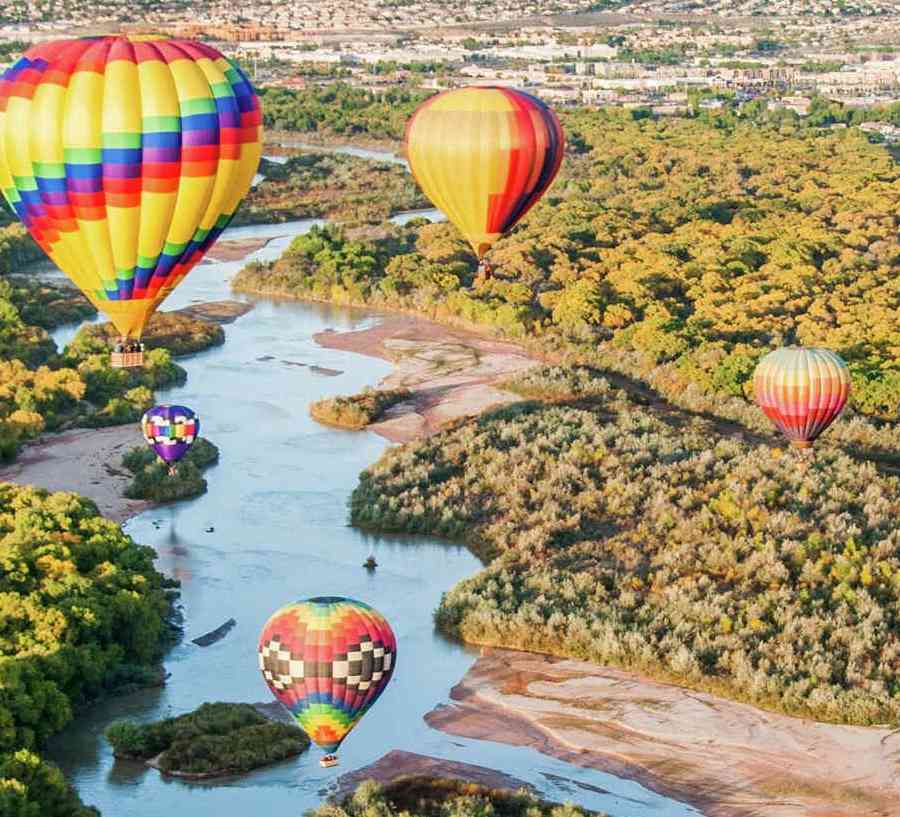 Hot air balloons floating over the Rio Grande near Albuquerque, New Mexico.