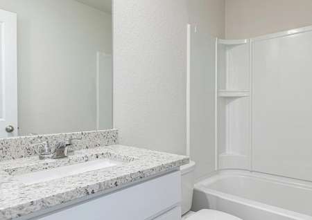 The spare bathroom has a spacious vanity