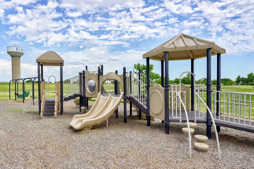 Crimson Lake Estates new home community children's playground with plenty of equipment, slides, and shading