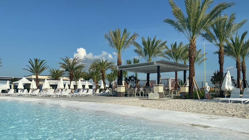 Lago Mar Beach cabanas, chairs and palm trees