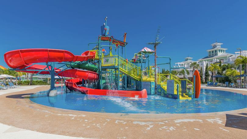Play area containing small water slides and staircases within 10-acre water park. 
