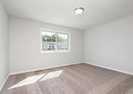 Interior photo of master bedroom with carpet and window.