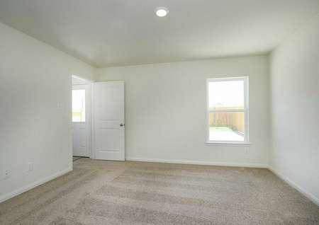 Trinity bedroom with white doors and baseboards, brown carpet, and white framed window