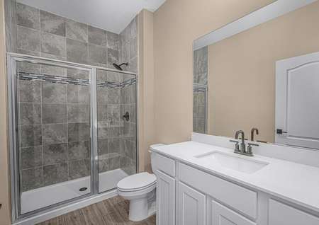 The master bathroom has a large vanity and a step-in shower