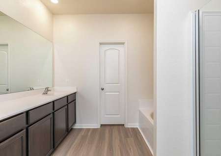 Cypress bathroom with separate bathtub and shower, ceramic flooring, and large white vanity