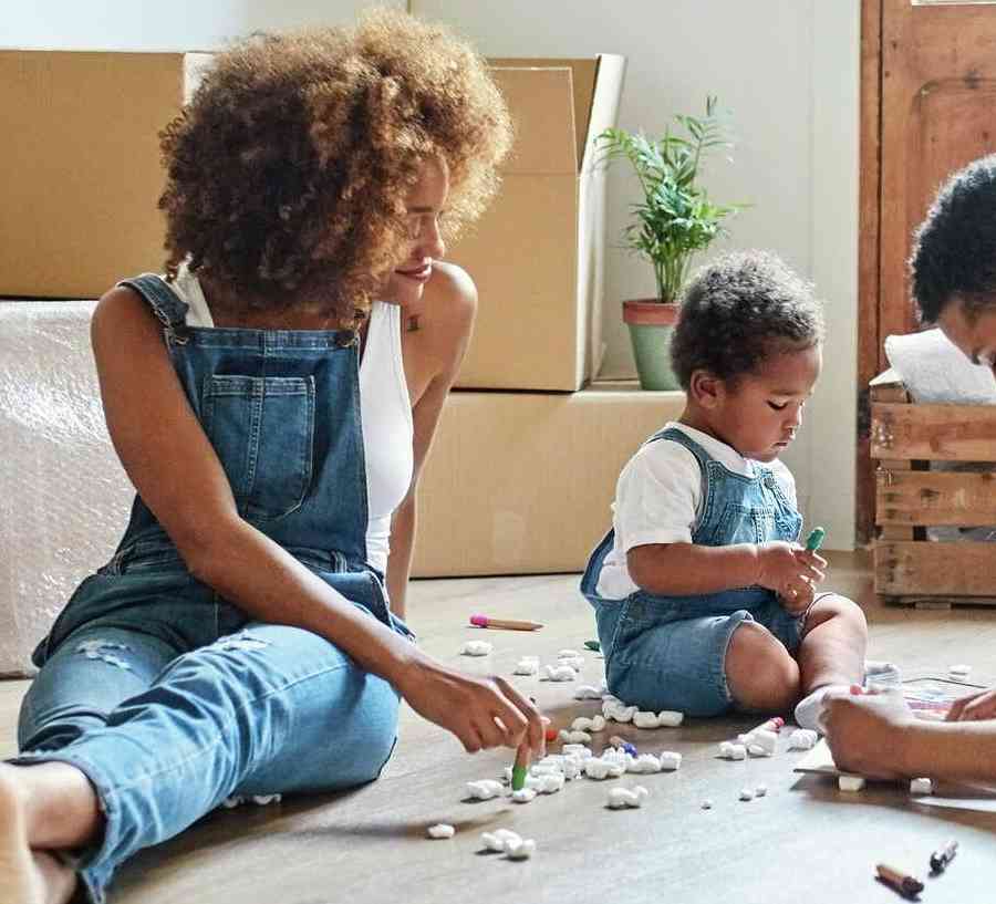 Family takes a break from moving into their new home.