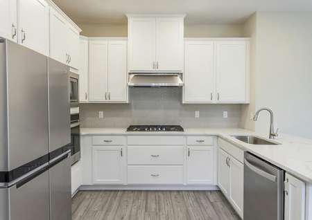 Stunning kitchen with quartz countertops and brand new stainless steel appliances.