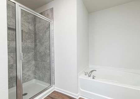 The master bathroom's shower is spacious and is beautifully tiled