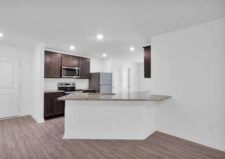 Kitchen featuring granite countertops, tall cabinets and all new appliances. 