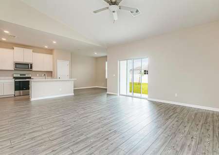 This bright and open entertainment space shows off the home's spacious kitchen, dining room and family room. 