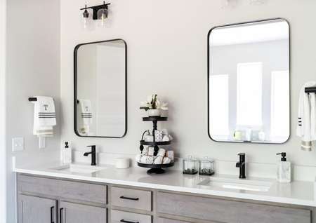 Dual-sink vanity with two mirrors and black accents