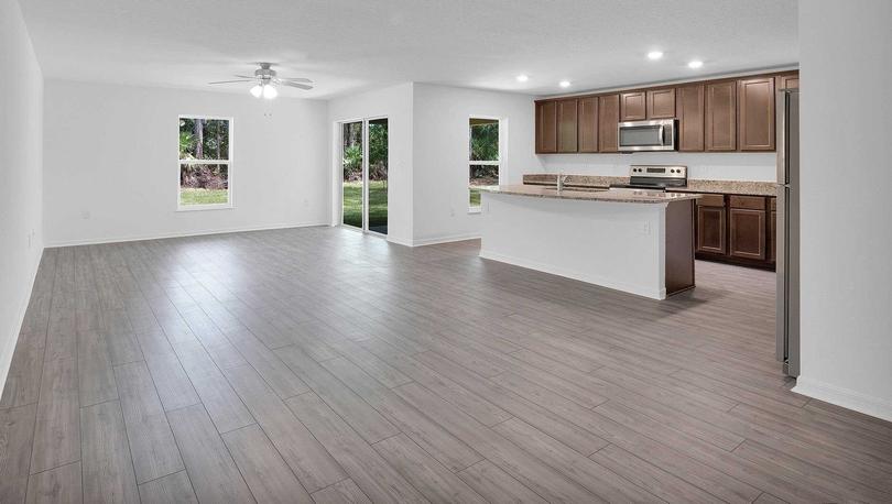 The family room stretching from the outdoor entertainment space to the chef-ready kitchen.