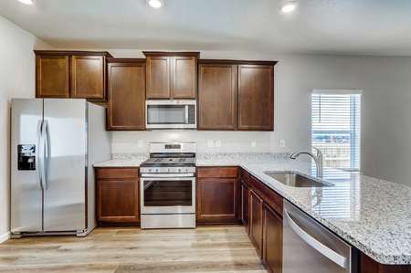 Arapaho kitchen with granite counters, stainless steel appliances, and undermount sink