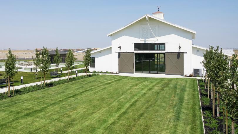 The Events Barn at Club Liberty with sliding barn doors, green grass and trees.