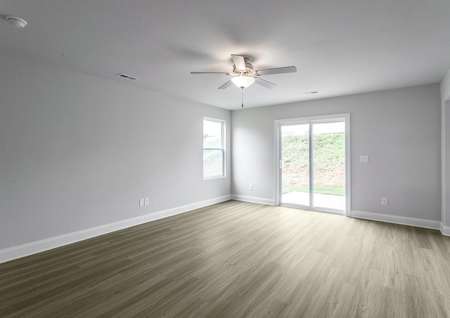 Living room with vinyl floors and a ceiling fan.