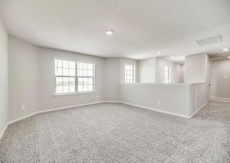 The upstairs game room offers light walls, light carpet and plenty of space for family fun.