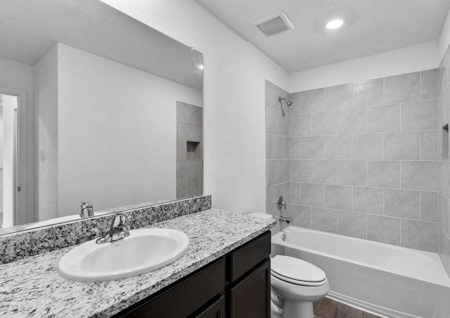 Secondary bathroom with a dual shower and tub.