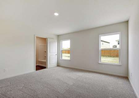 Medina family room with two backyard white framed windows, light gray carpet, and access to the kitchen