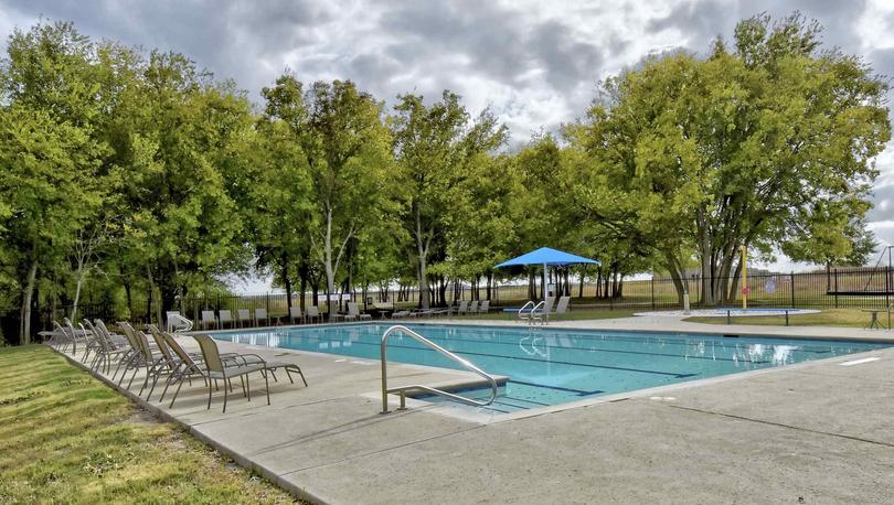 Bunton Creek new home community pool with swim lines and sunbathing chairs on deck 