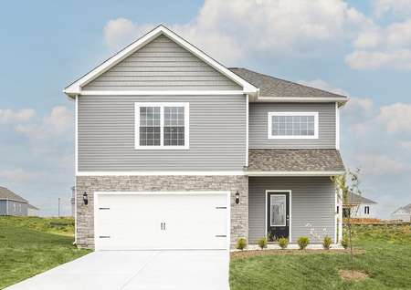 Photo of the front elevation of the Ashburn by LGI Homes with gray siding with white trim and light gray stone.