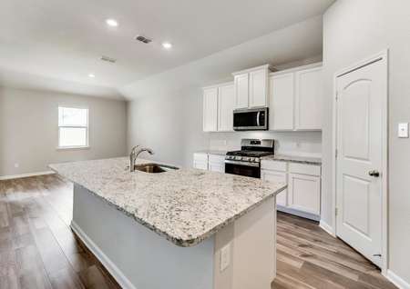 The kitchen comes complete with beautiful, white cabinetry and granite countertops.