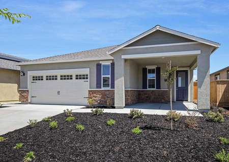 The stunning Baldwin plan with stucco, stone and charming window shutters.