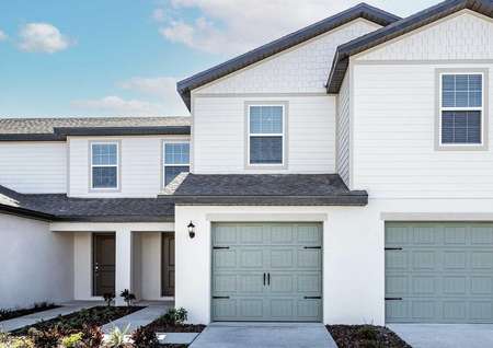Sizable, new-construction home with front yard landscaping and a one-car garage.