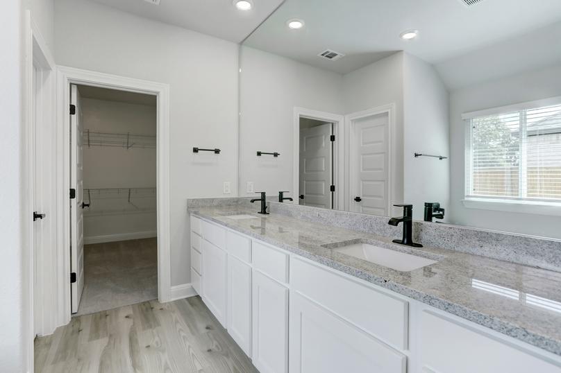 Master bathroom with a double-sink vanity, white cabinetry, and granite countertops.