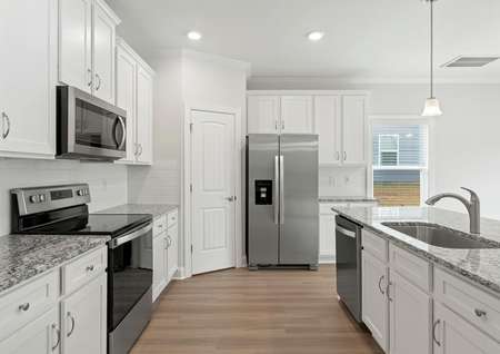 Kitchen with white cabinets and stainless appliances.