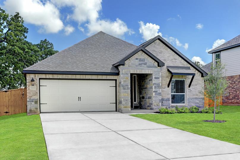 Exterior of the Connally with light gray brick and stone, professional landscaping, and a two-car garage.