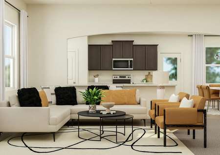 Rendering of the open floor plan's living
  area featuring large furniture and natural décor with a view of the kitchen
  in the background.