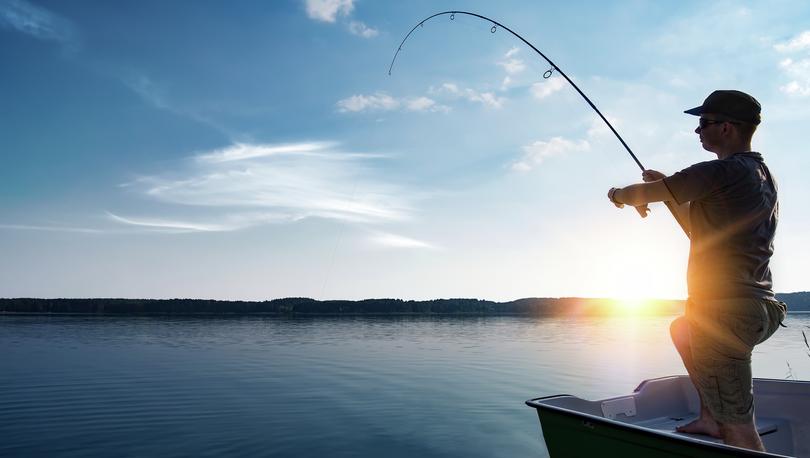 Man fishing at sunrise.