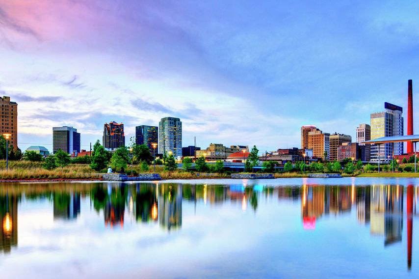 Birmingham, Alabama Railroad Park showing the cityscape, calm waters, and blue skies