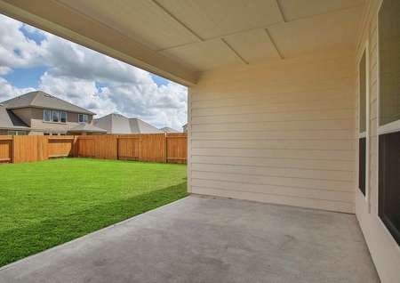 Exterior fenced in and landscaped back yard with covered back patio in the Marquette floor plan