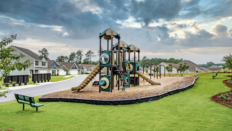 Playground at The Valley with slides, swings and a bench.