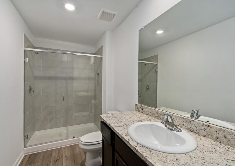Master bathroom with a walk-in shower and granite countertops.