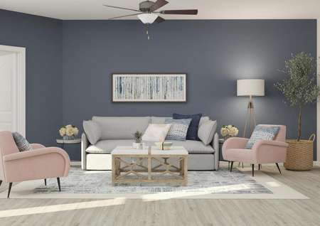 Rendering of the spacious living room in
  the Anna, which has wood-style flooring, a gray couch, two accent chairs and
  a coffee table. The master bedroom is visible through a doorway.