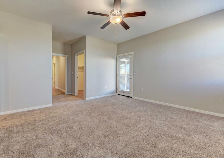 Cooley bedroom with ceiling fan, backyard door with window and blinds, and private bathroom