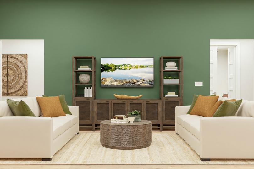 Rendering focusing on double cream sofas
  and coffee table in the living room. A large rug, green accent wall and
  wooden media center complete the relaxing space.