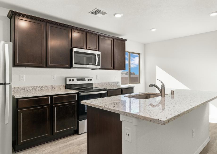 Chef-ready kitchen with a large island and sprawling granite countertops.