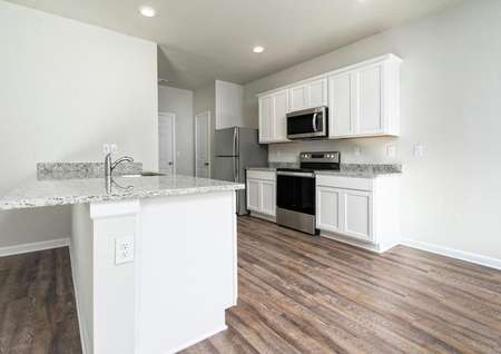 Chef-ready kitchen of the Burke with white cabinets and stainless steel appliances
