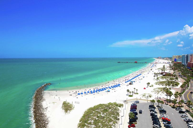 Tampa, Florida Clearwater Beach with white sands, green water, and blue sky