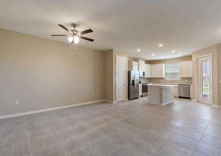 The Calabria floor plans living room that has tile flooring, a ceiling fan with lights, tan walls and white baseboards.