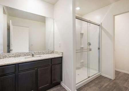 The Luna floorplan shows a glass walk in shower with vinyl wood floors.