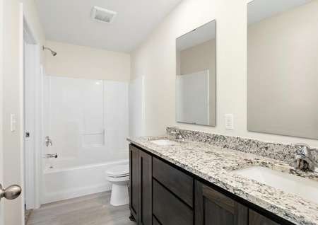 The master bathroom is spacious and has a double vanity