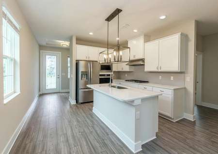 View of primary entrance leading to a chef-ready kitchen featuring quartz countertops and all new appliances.