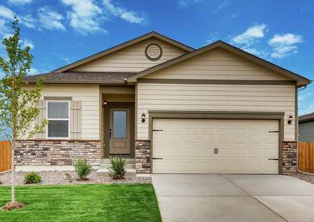 Arapaho finished exterior with landscaping, tan siding with dark brown trim, and two car garage
