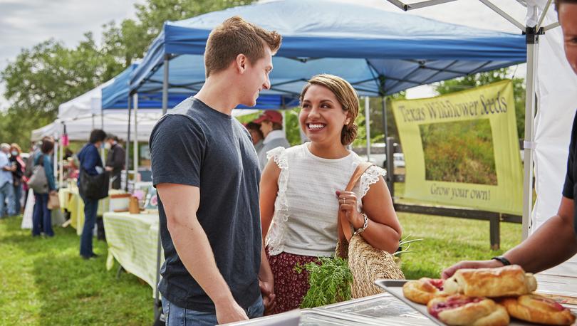 Young couple at outdoor market.